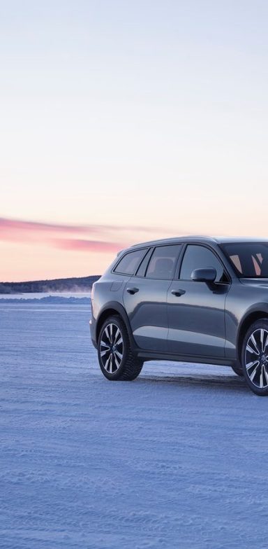 Voiture Volvo V60 sur un fond de neige, ciel clair et lumière du matin.